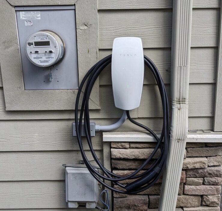 Tesla Wall Connector next to the utility meter on a home exterior, Vancouver WA
