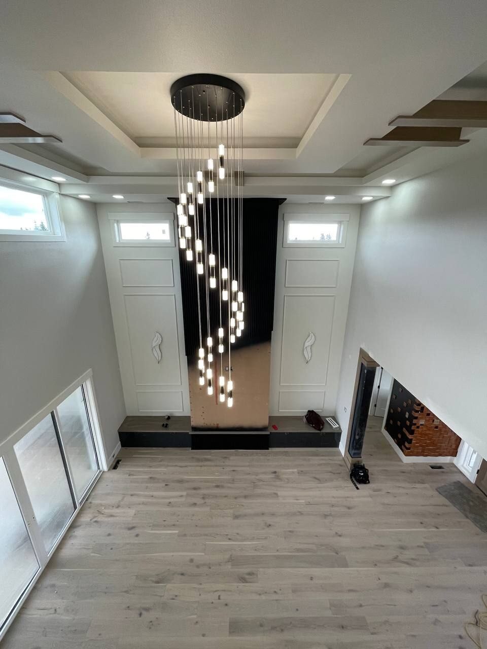 Cascading linear chandelier in a two storey entry, Clark County WA