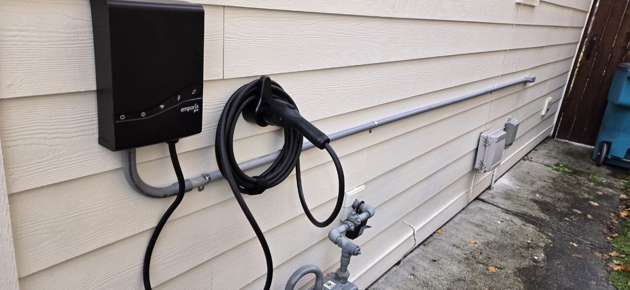 Level 2 EV charger mounted on the exterior siding of a home in Clark County WA